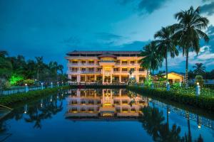 a resort with a canal in front of it at PJ Princess Regency in Cochin