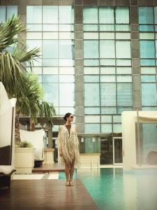 a woman standing in the middle of a building at Raffles Makati in Manila