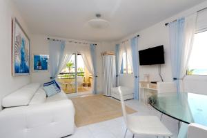 a living room with a white couch and a glass table at Very cozy apartment KATY by the sea in 2 km from Denia in Denia
