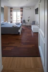 a bedroom with a bed and a living room at Guest House Vignola in Rome
