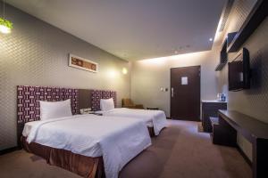 Voodi või voodid majutusasutuse Esun Villa Hotel toas
