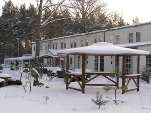 a snow covered picnic table in front of a building at Waldhotel Seelow in Seelow