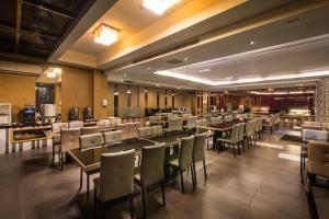 - un restaurant avec des tables et des chaises dans une salle dans l'établissement Esun Villa Hotel, à Chiayi