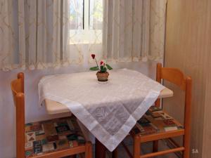 a table with a white table cloth and a flower on it at Bagoren in Metulla