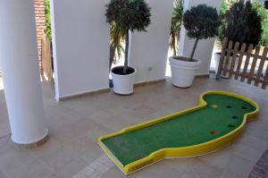 a green and yellow skateboard in a room with plants at Marine House Andrianna -Adults only in Siviri