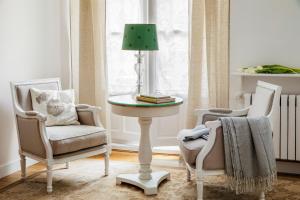 a room with two chairs and a table with a lamp at Hotel Infanta Isabel by Recordis Hotels in Segovia