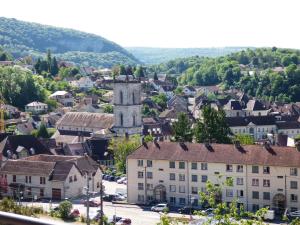 an aerial view of a town with a church at La Colline aux Yeux Doubs in Baume-les-Dames