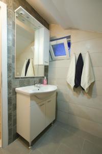 a bathroom with a sink and a mirror at Central Located Guest House in Mostar