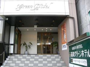 a building with a potted plant in front of it at Kochi Green Hotel Harimayabashi in Kochi