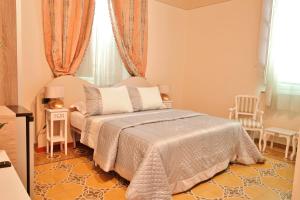 Postel nebo postele na pokoji v ubytování Lucca Relais