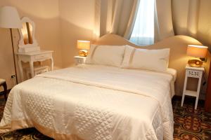 Postel nebo postele na pokoji v ubytování Lucca Relais