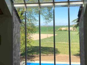 una ventana con vistas al campo desde una casa en Majestic villa in Cussay with swimming pool en Cussay