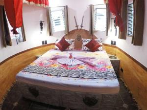 a bedroom with a large bed with a flower design at Takatuka Beach Resort in Sipalay