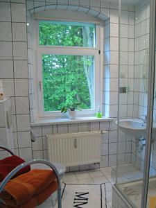 a bathroom with a window and a sink at Hotel-Pension Königswald in Dresden