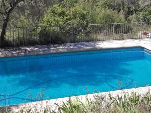 a swimming pool with blue water in a yard at Elegant holiday home with private pool in Masseboeuf