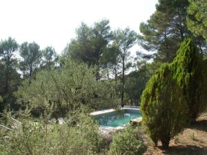 a swimming pool in a garden with trees at Elegant holiday home with private pool in Masseboeuf