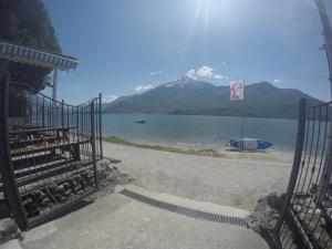 a gate with a view of a lake and a mountain at Camping Villaggio Paradiso in Domaso