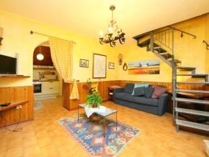 a living room with a couch and a staircase at Eremo di Santo Apollinare in Messenano