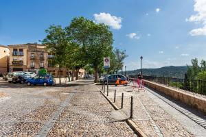 a street with cars parked on the side of the road at Apartamento Greco Toledo in Toledo