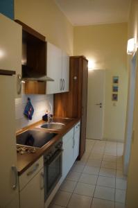 eine Küche mit Spüle und Herd oberen Backofen in der Unterkunft Ferienwohnung Sandrose in Wangerooge
