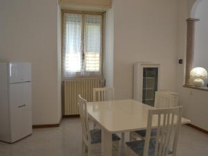 a white dining room table and chairs in a kitchen at L'Antico Borgo in Lesa