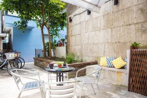 a table and chairs sitting on a patio at On My Way Hualien Hostel in Hualien City