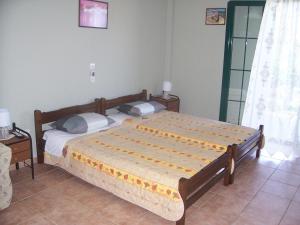 a bedroom with a large bed in a room at Anastasis Apartments in Trapezaki