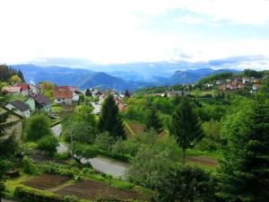 a town with trees and houses and mountains in the background at Apartment Pogled in Skrad