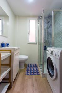 a bathroom with a washing machine and a shower at Versus Apartment near City of Arts in Valencia