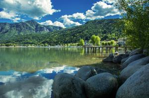 a view of a lake with rocks and mountains at La terrazza sul lago in Pergine Valsugana