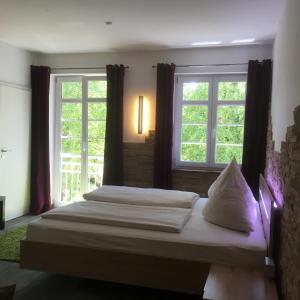 オーバーアマガウにあるアルテ ポストヴィラのベッドルーム1室(ベッド2台、窓2つ付)