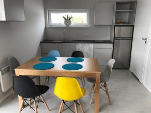 a kitchen with a table and chairs in a room at Palm Rogowo in Rogowo