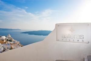 a sign for a hotel on the side of a building at Asteras Villas in Fira