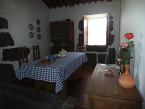 a dining room with a table and a window at Casa da Madrinha Graciosa in Trás dos Pomares +14 photos