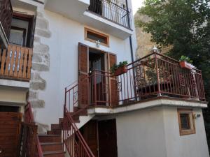an apartment building with balconies and a staircase at Grottino Apartment in San Potito