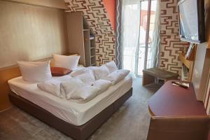 Postel nebo postele na pokoji v ubytování Flair Hotel Zum Schwarzen Reiter