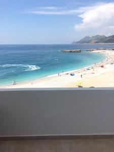 a view of a beach with people in the water at Apartments Sidro in Dobra Voda