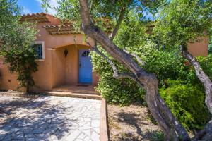 a house with a blue door and a tree at Luxueuse Villa - Golfe de St Tropez in Sainte-Maxime