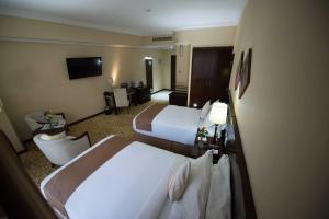 
A bed or beds in a room at Capital Hotel and Spa
