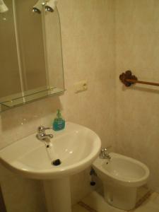a bathroom with a sink and a toilet at La Coruxa in Los Cabos +17 photos