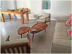 a living room with two chairs and a table at Ayoba Santorini in Imerovigli