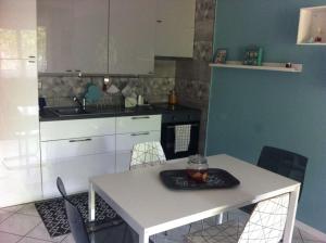 a kitchen with a table with a plate on it at Appartamento al Parco CIR03407AT00243 in Parma +6 photos