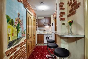 a kitchen with two stools in front of a door at Retro Moscow on Kurskaya in Moscow