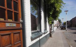 un edificio con una ventana en el lateral de una calle en Frank's Backpackers, en Helmond