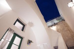 an attic room with a staircase and a window at Petrarussa Dimora Storica in Morciano di Leuca +52 photos
