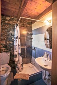 a bathroom with a toilet and a sink at Ihnilatis in Kerkini