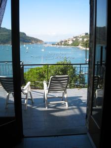 a balcony with two chairs and a view of a harbor at Profumi di Mare in Portovenere