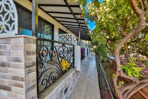 a house with a wrought iron fence at Hamarat Otel in Kaş