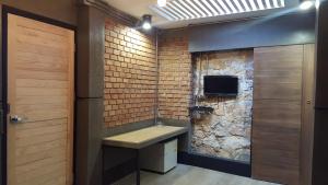 a bathroom with a stone wall and a sink at I-Talay Loft in Ko Samed