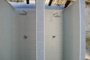 a bathroom with a shower with blue tiles at Hotel Regina del Mare in Ischia
